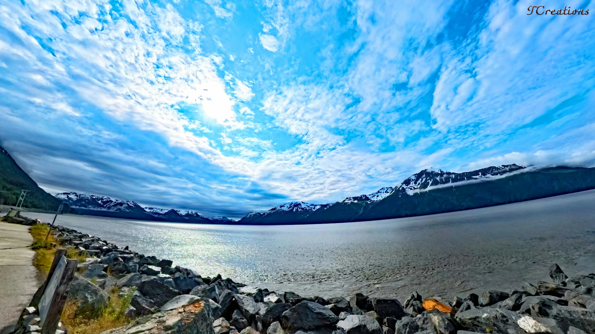Turnagain Arm, Alaska — snow peaks above still blue water